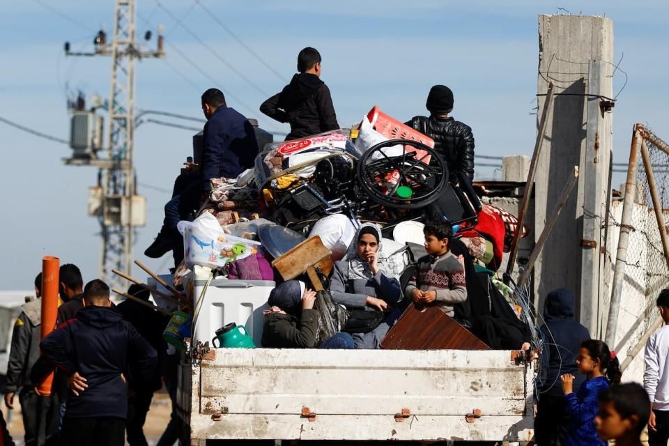 Displaced Palestinians who fled their homes to escape Israeli strikes ride a vehicle in Rafah in southern Gaza Strip. (Ibraheem Abu Mustafa/Reuters - image credit)