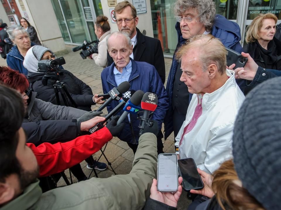 Robert Mailman, left, and Walter Gillespie, speak to media shortly after their hearing at Saint John Law Courts in Saint John, N.B., January 4, 2024. The two men recently had a 1984 murder conviction overturned and have now been found formally not guilty.
