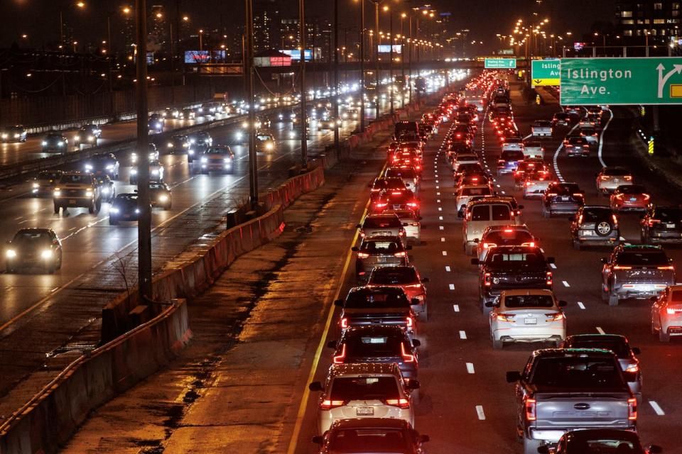 Commuters drive through rush hour traffic on Queen Elizabeth Way, in Toronto, on Jan. 11, 2024.