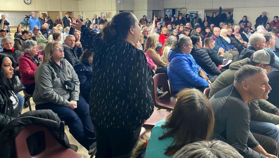A woman speaks during a public meeting about the Beacon House shelter expansion to add Pallet units in Lower Sackville on Thursday. (Haley Ryan/CBC - image credit)