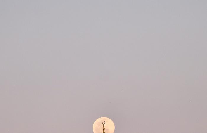مصور يرصد القمر فوق مآذن المساجد في الإمارت بصور آسرة